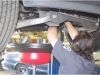 Auto mechanic performing oil change